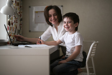 tutor teach preschooler with laptop, real home