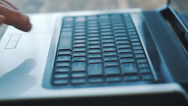 Man Fingers Taping Keyboard Notebook Computer. Close up.