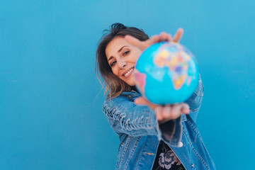 Smiling woman holding a globe in her hands