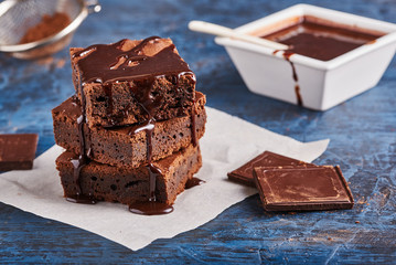 homemade chocolate brownies on dark blue background