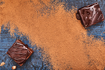 homemade chocolate brownies on dark blue background, top view