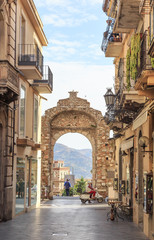 Messina Gate (Porta Messina) in Taormina. It is north entrance of  historical center of town which leads to  main street of Taormina - obrazy, fototapety, plakaty