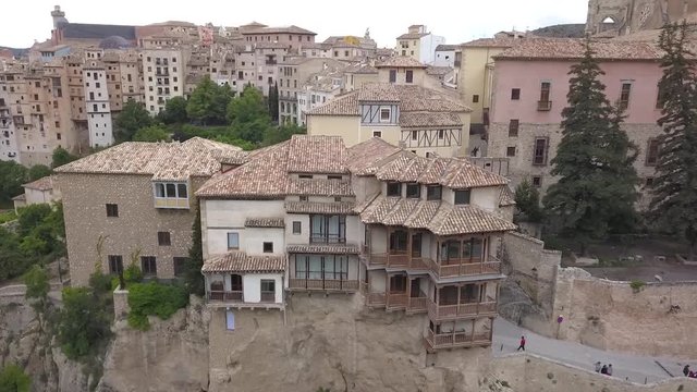 Aerial view of the Hanging houses of Cuenca, Spain. These historical houses have balconies that are hanging off a cliff in the middle of a valley.