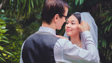 Beautiful loving couple bride and groom enjoying their wedding day outdoors in the park.