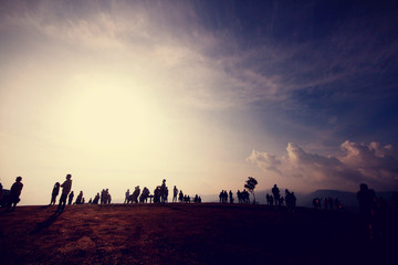 Fototapeta na wymiar Silhouette of people in beautiful sunrise on the mountain at Thailand. Ultra violet and copy space.