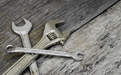 old wrench steel tools on aging wood background