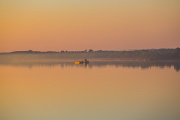 quiet lake scene at the early morning in a mist