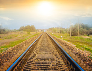 Fototapeta na wymiar railway among a prairie to a sunset