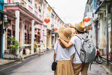 Young couple traveler walking at Phuket old town in Thailand - obrazy, fototapety, plakaty