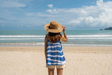 Fototapeta na wymiar Young woman relaxing and enjoying at the tropical beach