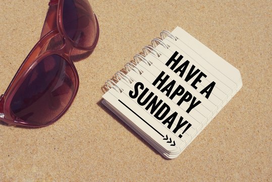 Motivational and inspirational quote - ‘Have a happy Sunday’ written  on a wooden blocks. 