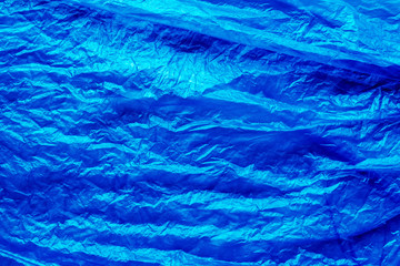 Crumpled blue plastic sheet material texture