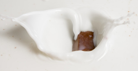 Chocolate falls in milk