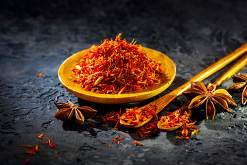Saffron. Various Indian Spices on black stone table. Spice and herbs on slate background. Cooking...