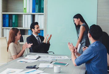 Woman of business discussing ducuments and ideas at meeting.