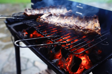 pork ribs on the grill cooking coals / fresh meat pork cooked on charcoal, summer home cooked meal,...