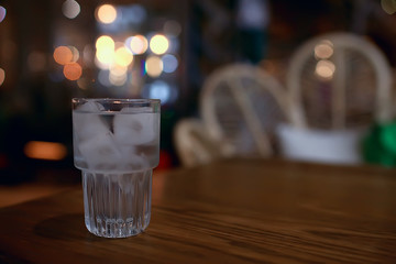 glass of water with ice in the restaurant / cold clear clear water in a glass with ice pieces