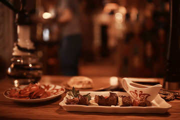 steak in the restaurant on the table / dinner in the restaurant, meat on the plate, served steak and cutlery