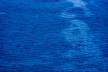Aerial view of the sea surface. High resolution bird's eye image showing sea waves and currents from above.