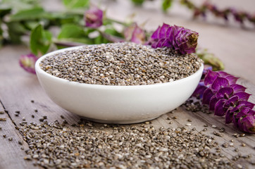 Chia seeds healthy superfood with flower on wooden table