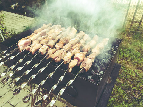 Mcvadi - shashlik preparing on a barbecue grill over charcoal. Roasted stacked meat traditional cuisine in Georgia