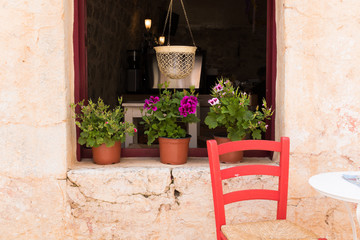 Fototapeta na wymiar Window with flowers and a chair