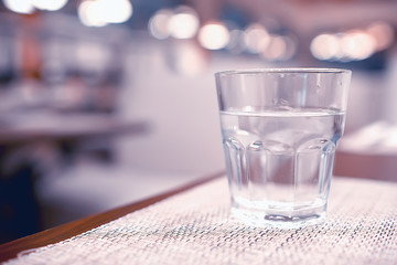 glass of water with ice in the restaurant / cold clear clear water in a glass with ice pieces