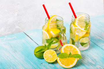 citrus fresh lemonade soda ice mint lemon lime wooden background
