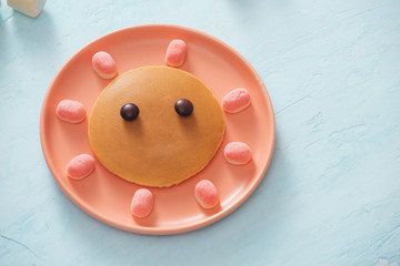 Tasty fried pancake with beautiful face isolated, sweet dessert