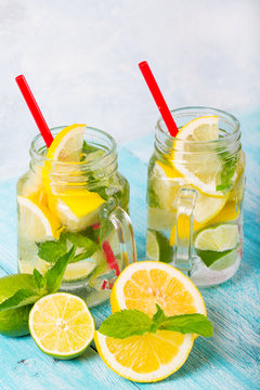 citrus fresh lemonade soda ice mint lemon lime wooden background
