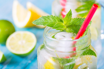 citrus fresh lemonade soda ice mint lemon lime wooden background
