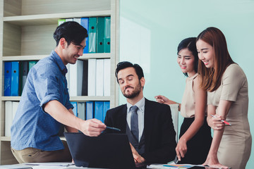 Group of business discussing ducuments and ideas at meeting.