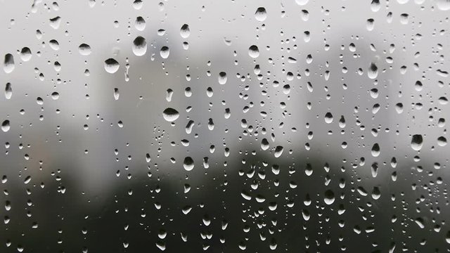 Raindrops drip on the window