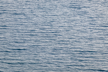 Aerial view of the sea surface. High resolution bird's eye image showing sea waves and currents...
