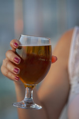 a girl holding beer glass at restaurant