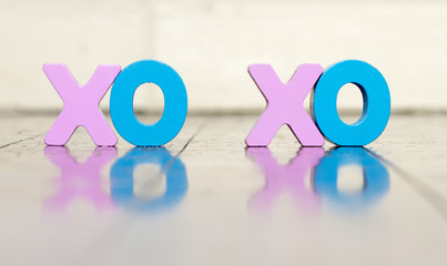 XO XO wooden letters on a old wooden floor with reflection