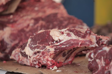 red meat steak detail photography taken on a street african market, on a sunny summer day