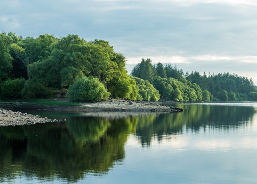 View of Fontburn Reservoir, Northumberland, England, UK, in evening light.