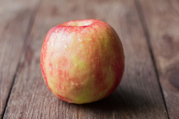 red juicy Apple on wooden background