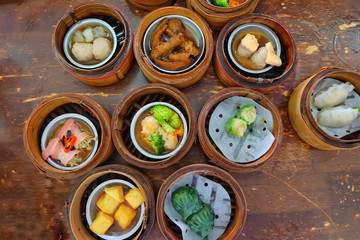 The Chinese food ,A many kind of Dim Sum in bamboo basket on table in chinese food restaurant.