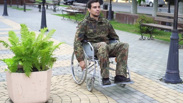 A disabled soldier in a wheelchair in camouflage
