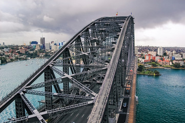 View of Sydney Harbour Bridge from the south-eastern pylon containing the tourist lookout towards North Sydney. Cloudy day before storm.