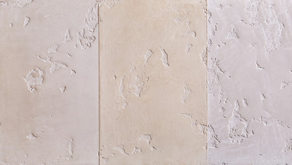 Close-up surface detail of old rough white plaster wall texture, macro.