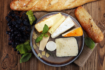 Cheese platter with different cheese on rustic plate