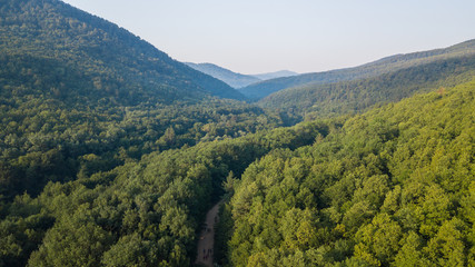 Russian Forest And Mountains Under Blue Sky By Aerial Drone. Stunning Aerial Drone Stock Footage of South russian Forest And Mountains Under Blue Sky