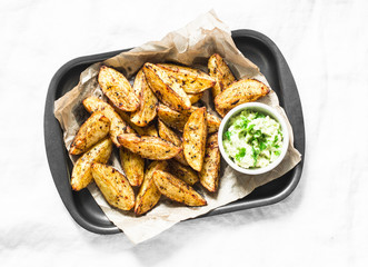 Baked potato with avocado salsa on light background, top view. Delicious snack or appetizers. Vegetarian food