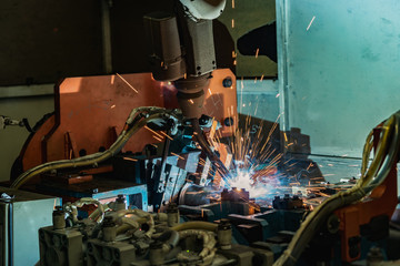 Industrial robot is welding  car part in factory
