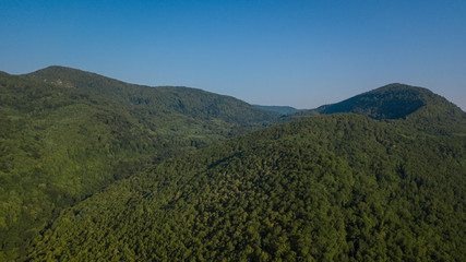 Obraz premium Russian Forest And Mountains Under Blue Sky By Aerial Drone. Stunning Aerial Drone Stock Footage of South russian Forest And Mountains Under Blue Sky
