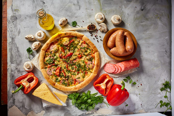 Fototapeta na wymiar Tasty Italian pizza and its ingredients on white textured background.