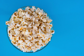 Popcorn viewed from above on blue background. Top view.